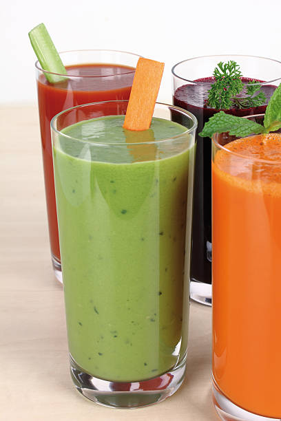 Glass of vegetable juice on wooden table