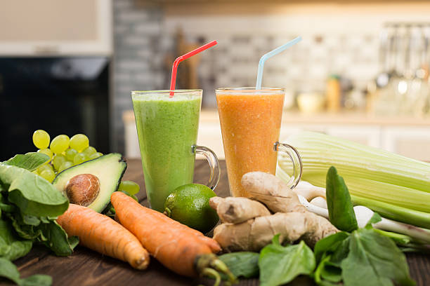 Fresh vegetable smoothies on wooden kitchen table